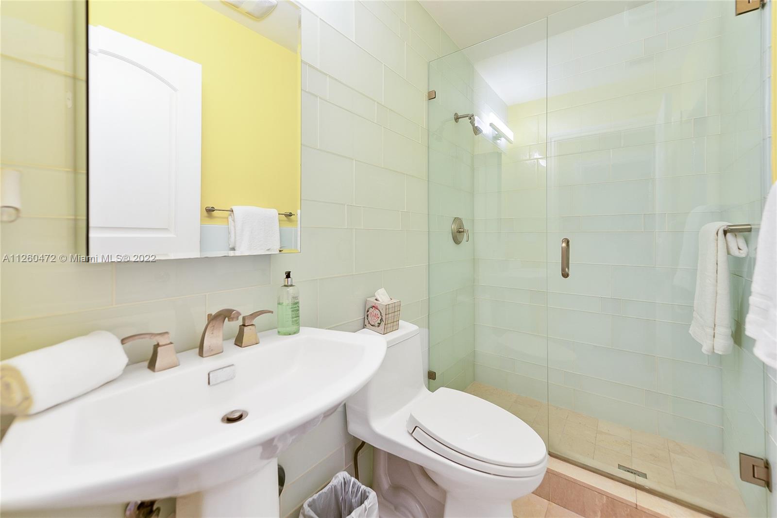 2153 North Bay Road Miami Beach, FL 33140 - Photo 10 of 19 a bathroom with a sink mirror and toilet