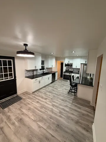 a kitchen with furniture and a wooden floors