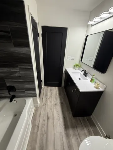 a bathroom with a sink a mirror and shower