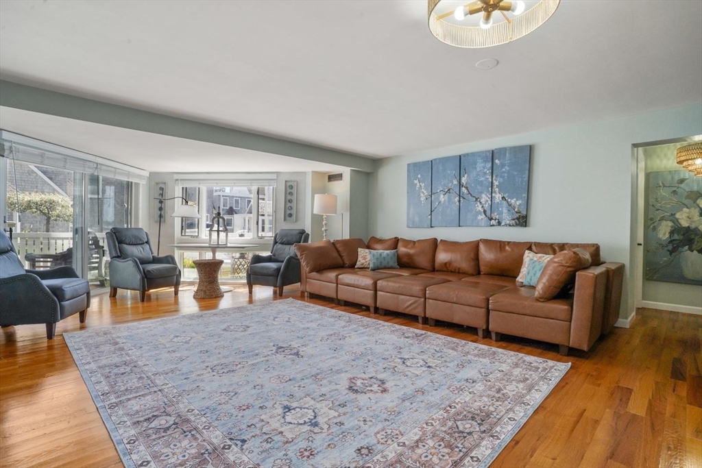 1 Commodore Court, Unit 104 Hull, MA 02045 - Photo 6 of 35 a living room with furniture wooden floor and a window