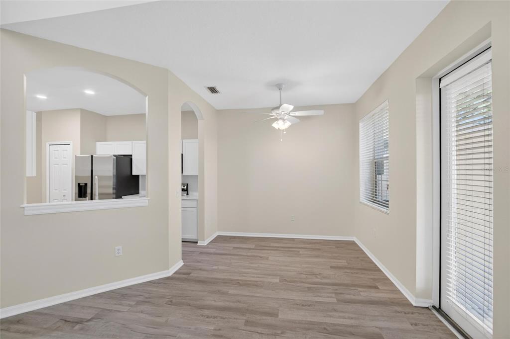 6418 Rosefinch Court, Unit 103 Lakewood Ranch, FL 34202 - Photo 11 of 48 a view of an empty room with wooden floor and a window