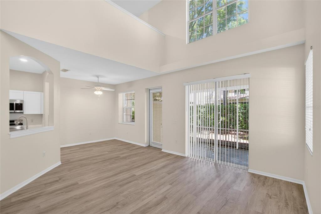 6418 Rosefinch Court, Unit 103 Lakewood Ranch, FL 34202 - Photo 13 of 48 an empty room with wooden floor and windows