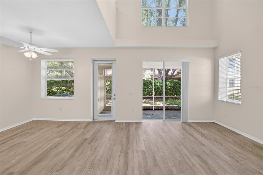 6418 Rosefinch Court, Unit 103 Lakewood Ranch, FL 34202 - Photo 14 of 48 a view of an empty room with wooden floor and a window