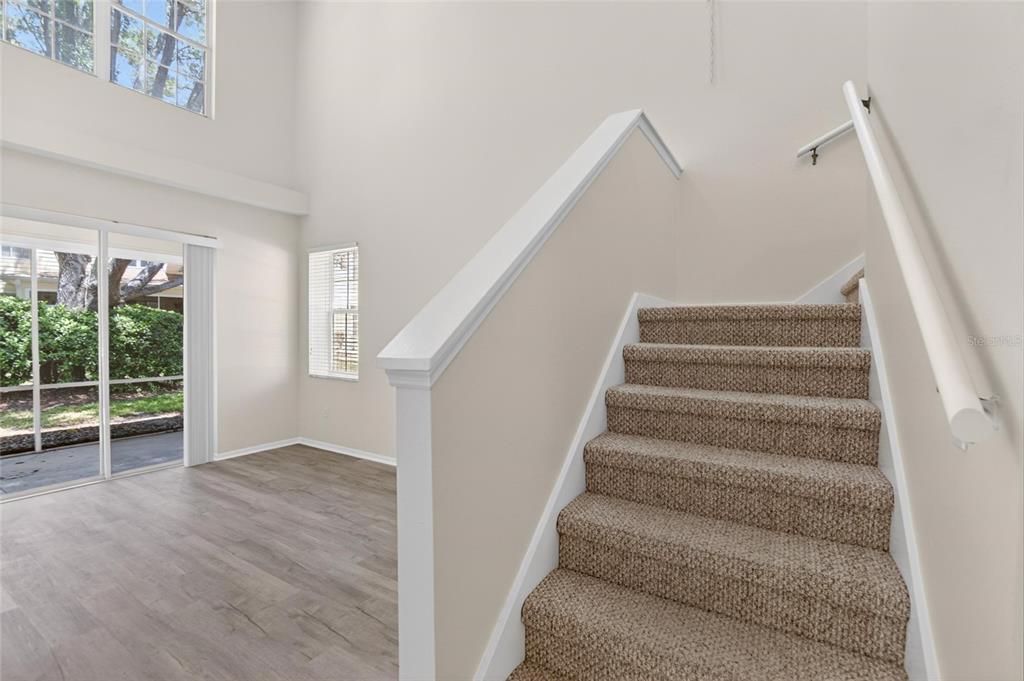 6418 Rosefinch Court, Unit 103 Lakewood Ranch, FL 34202 - Photo 15 of 48 a view of entryway and hall with wooden floor