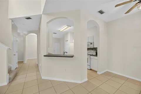 a view of a kitchen with kitchen island wooden floor and refrigerator