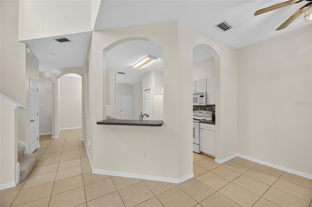6418 Rosefinch Court, Unit 103 Lakewood Ranch, FL 34202 - Photo 15 of 52 a view of a kitchen with kitchen island wooden floor and refrigerator