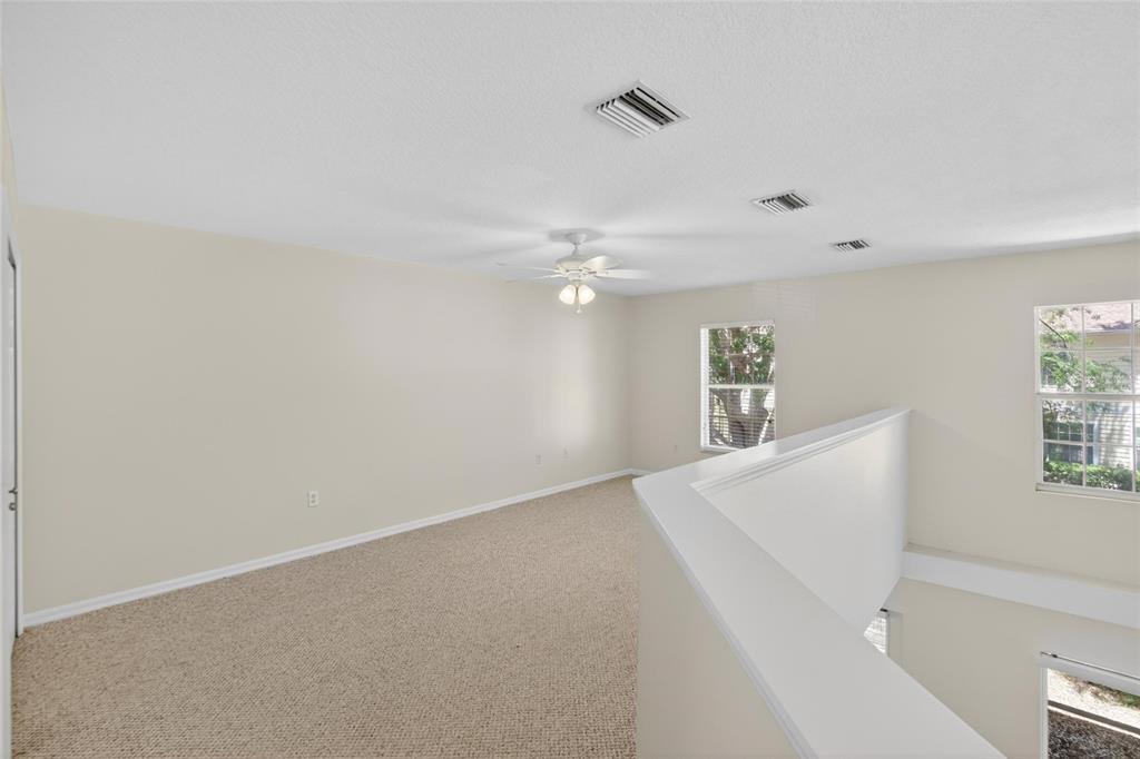 6418 Rosefinch Court, Unit 103 Lakewood Ranch, FL 34202 - Photo 16 of 48 a view of a livingroom with a ceiling fan and window
