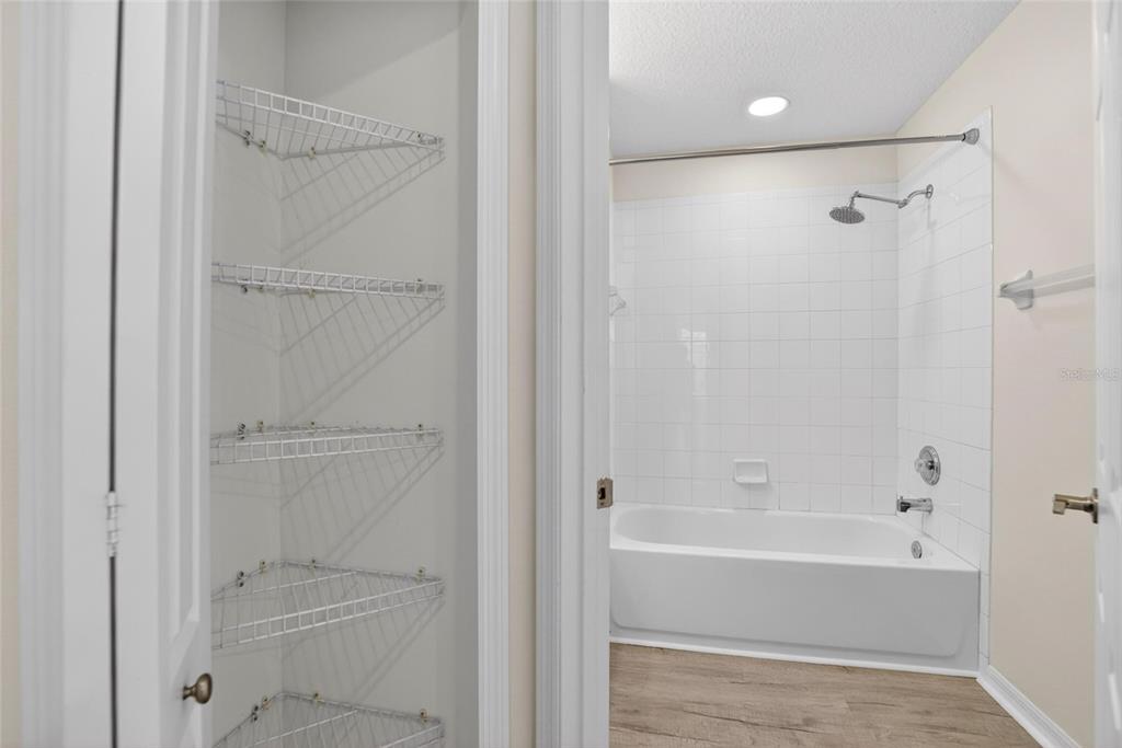6418 Rosefinch Court, Unit 103 Lakewood Ranch, FL 34202 - Photo 24 of 48 a bathroom with a bathtub and a shower