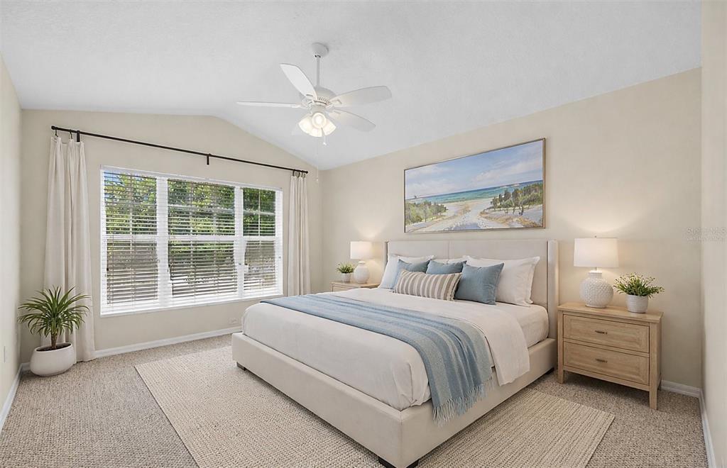 6418 Rosefinch Court, Unit 103 Lakewood Ranch, FL 34202 - Photo 26 of 48 a bedroom with a large bed and a window