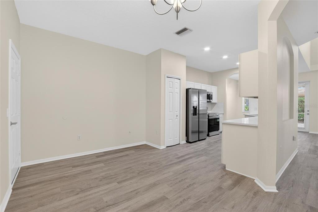 6418 Rosefinch Court, Unit 103 Lakewood Ranch, FL 34202 - Photo 3 of 48 a view of a kitchen with refrigerator and wooden floor