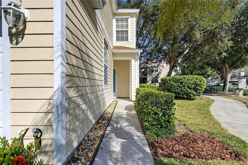 6418 Rosefinch Court, Unit 103 Lakewood Ranch, FL 34202 - Photo 3 of 52 a view of a pathway of a house with a yard
