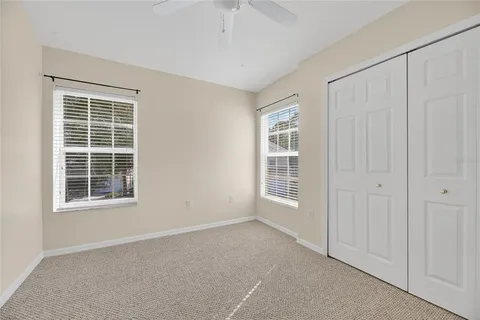 a bathroom with a granite countertop sink a mirror a bathtub and shower
