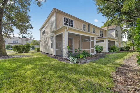 a view of a house with a yard and a garage