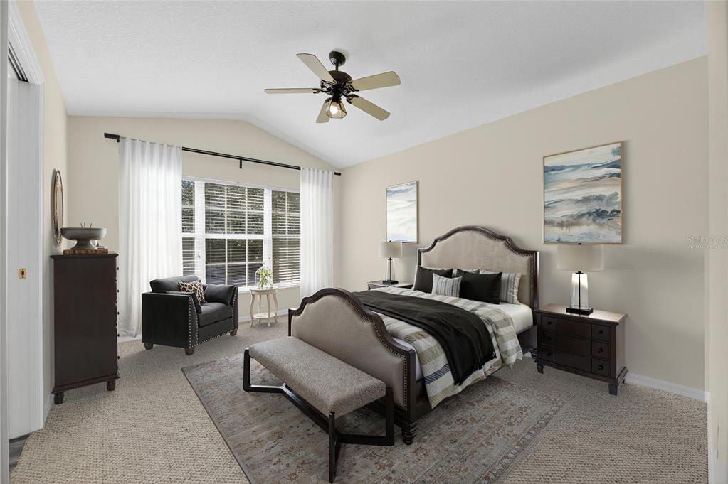 6418 Rosefinch Court, Unit 103 Lakewood Ranch, FL 34202 - Photo 38 of 52 a spacious bedroom with a bed and a couch