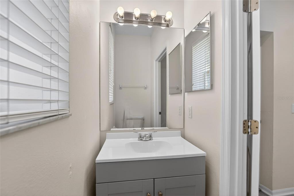 6418 Rosefinch Court, Unit 103 Lakewood Ranch, FL 34202 - Photo 5 of 48 a bathroom with a sink and a mirror