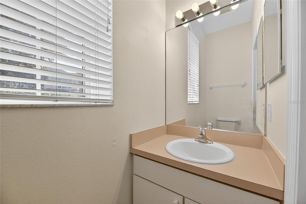 6418 Rosefinch Court, Unit 103 Lakewood Ranch, FL 34202 - Photo 6 of 52 a bathroom with a granite countertop sink and a mirror