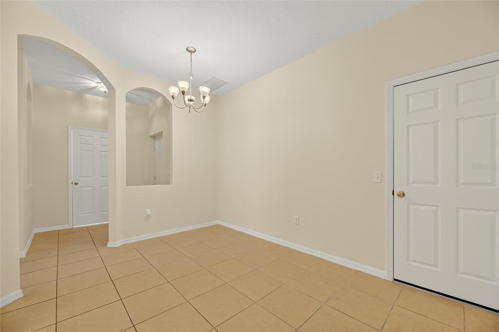 6418 Rosefinch Court, Unit 103 Lakewood Ranch, FL 34202 - Photo 8 of 52 a view of a chandelier in an empty room