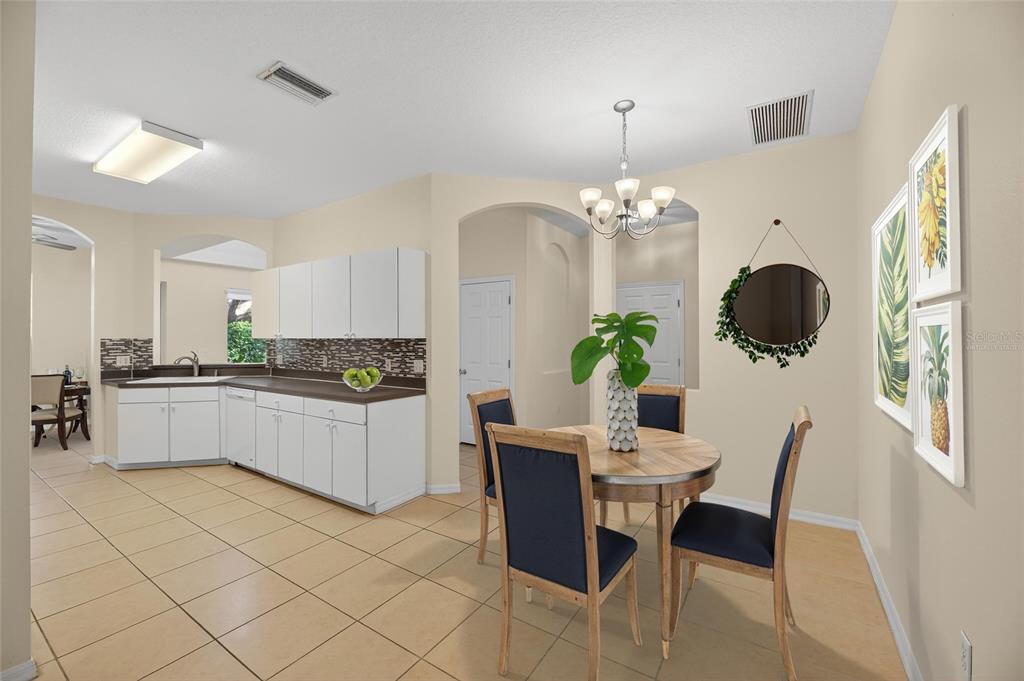 6418 Rosefinch Court, Unit 103 Lakewood Ranch, FL 34202 - Photo 9 of 52 a kitchen with a table and chairs in it