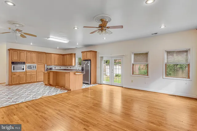 a view of a kitchen with wooden floor and a kitchen