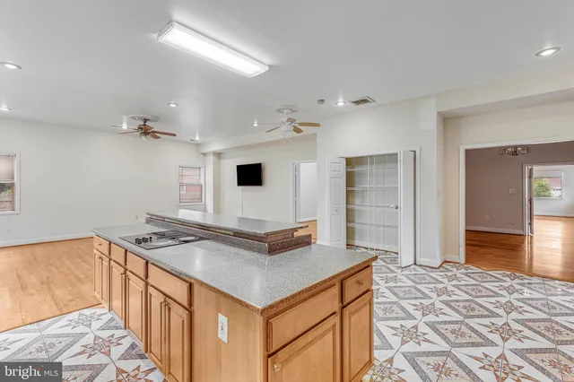 a kitchen that has a sink and a stove in it