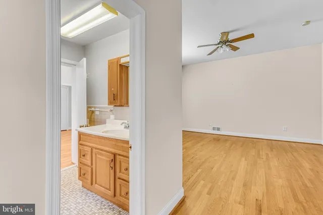 a en suite bathroom with a granite countertop sink and a mirror
