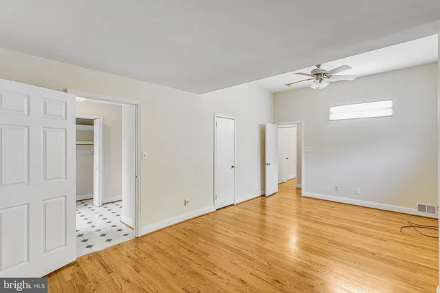a view of a room with wooden floor and white walls