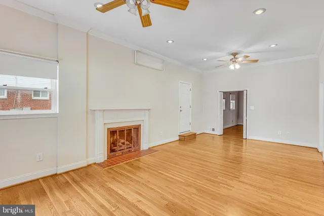 an empty room with fan and a ceiling fan