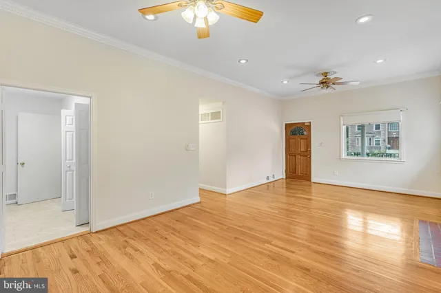 wooden floor in an empty room with a window
