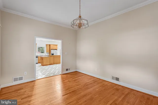 a view of a room with wooden floor and windows