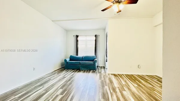 a view of a room with wooden floor
