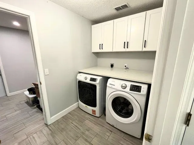 a view of a storage and utility room with washer and dryer