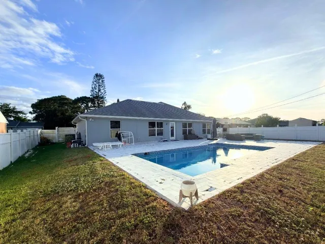 a view of a house with backyard porch and sitting area