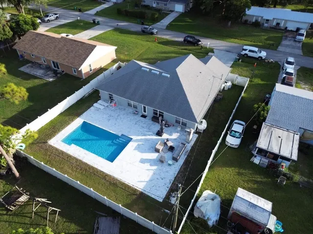 an aerial view of a pool patio yard and outdoor seating