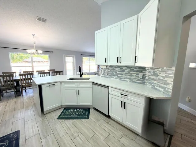 a kitchen with a sink stove and cabinets