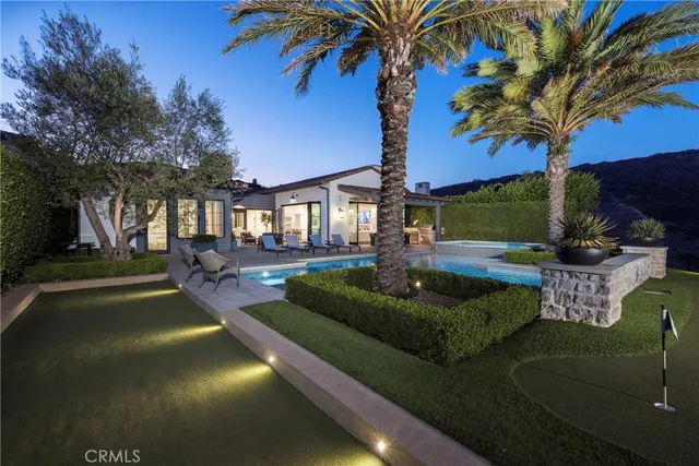 a view of a house with swimming pool and a yard