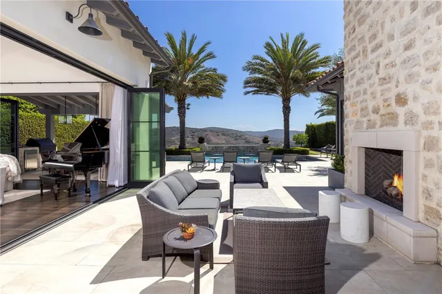 a living room with fireplace furniture and a potted plant
