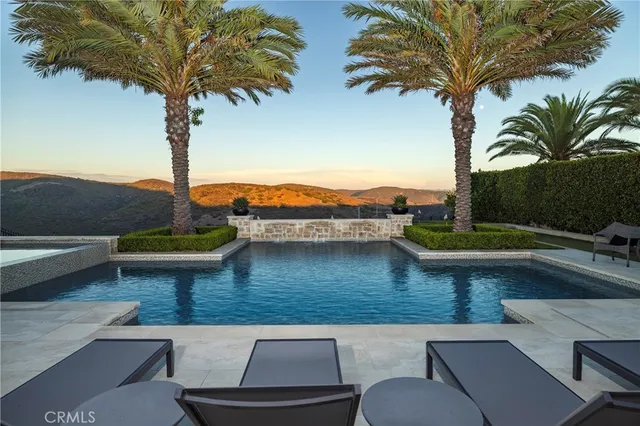 a view of a swimming pool with a table and chairs