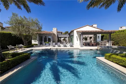 a swimming pool view with a seating space