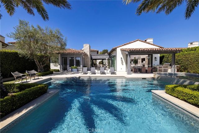 a swimming pool view with a seating space