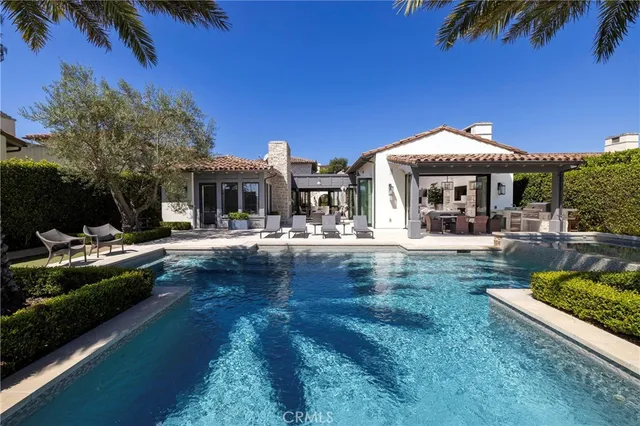 a swimming pool view with a seating space