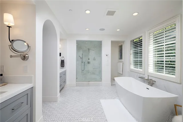 a bathroom with a double vanity sink a toilet and shower