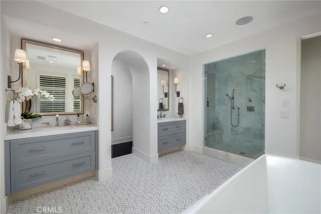 a bathroom with a granite countertop sink mirror and shower