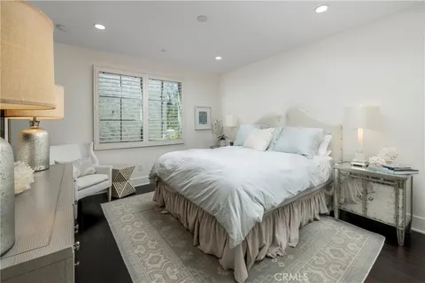 a spacious bedroom with a bed and a large window