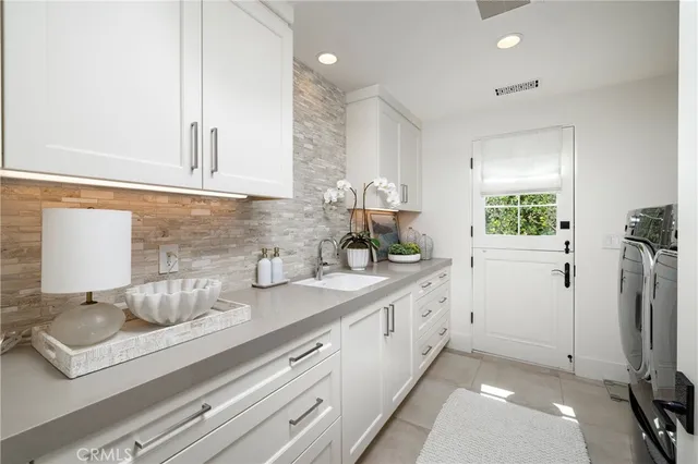 a kitchen with a sink appliances and cabinets