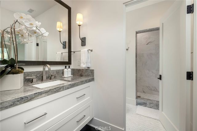 a bathroom with a granite countertop sink mirror and double