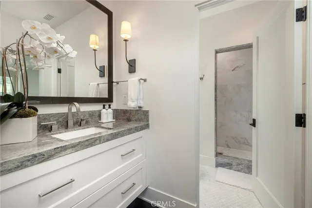 a bathroom with a granite countertop sink mirror and double