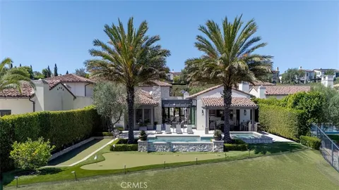 a view of a house with swimming pool and sitting area