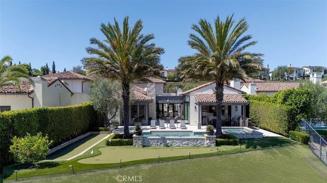 a view of a house with swimming pool and sitting area