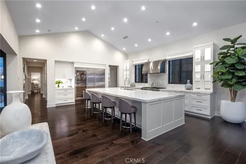 a open kitchen with stainless steel appliances granite countertop a lot of counter space dining table and chairs