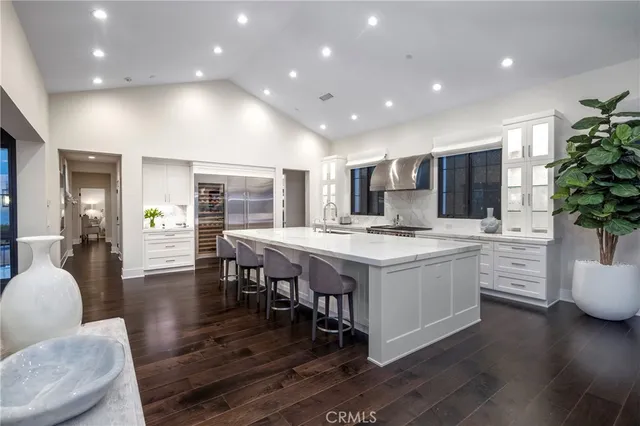 a open kitchen with stainless steel appliances granite countertop a lot of counter space dining table and chairs
